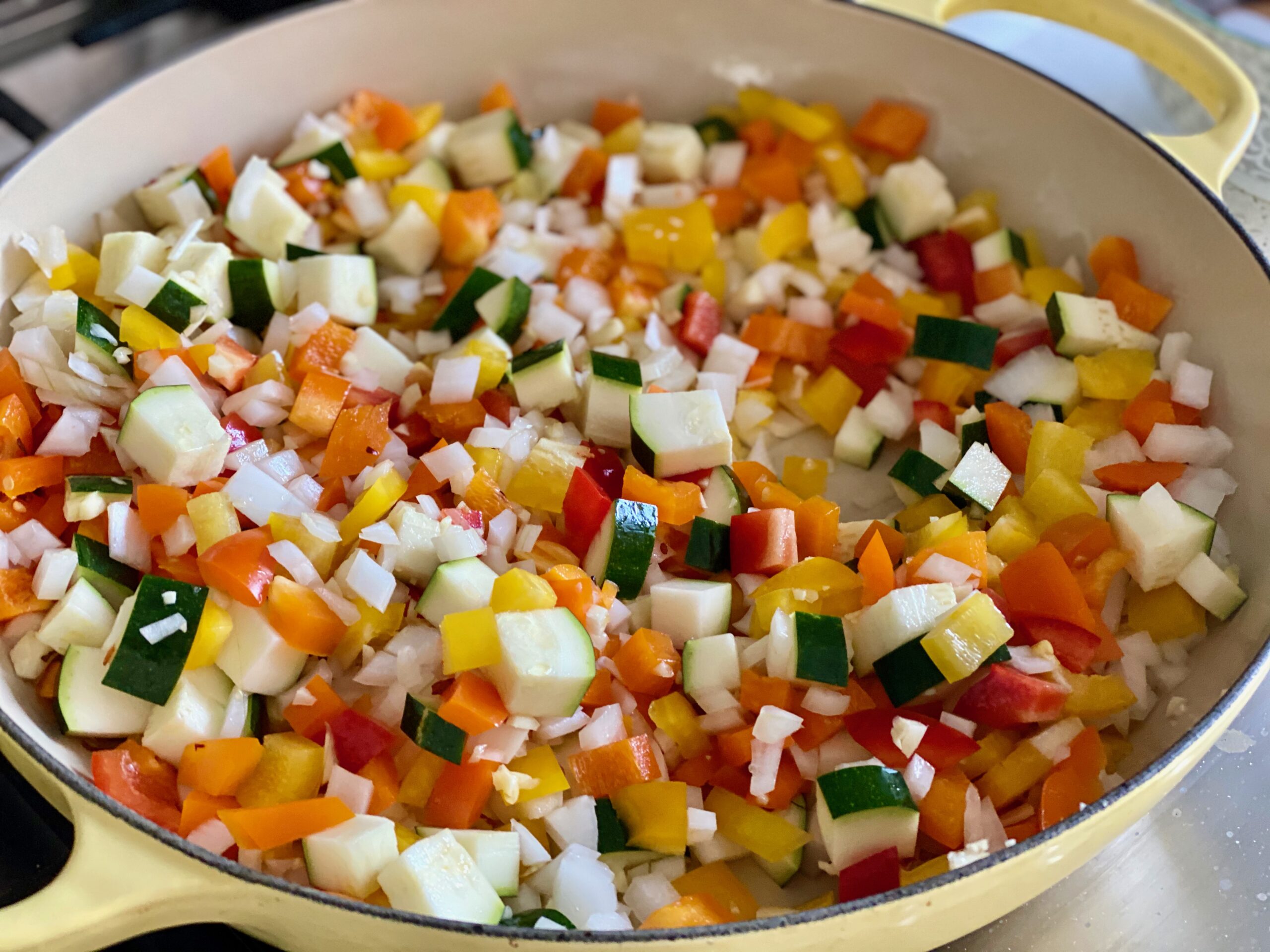 one pan unstuffed bell peppers A pan of pepper, onions and zucchini cooking