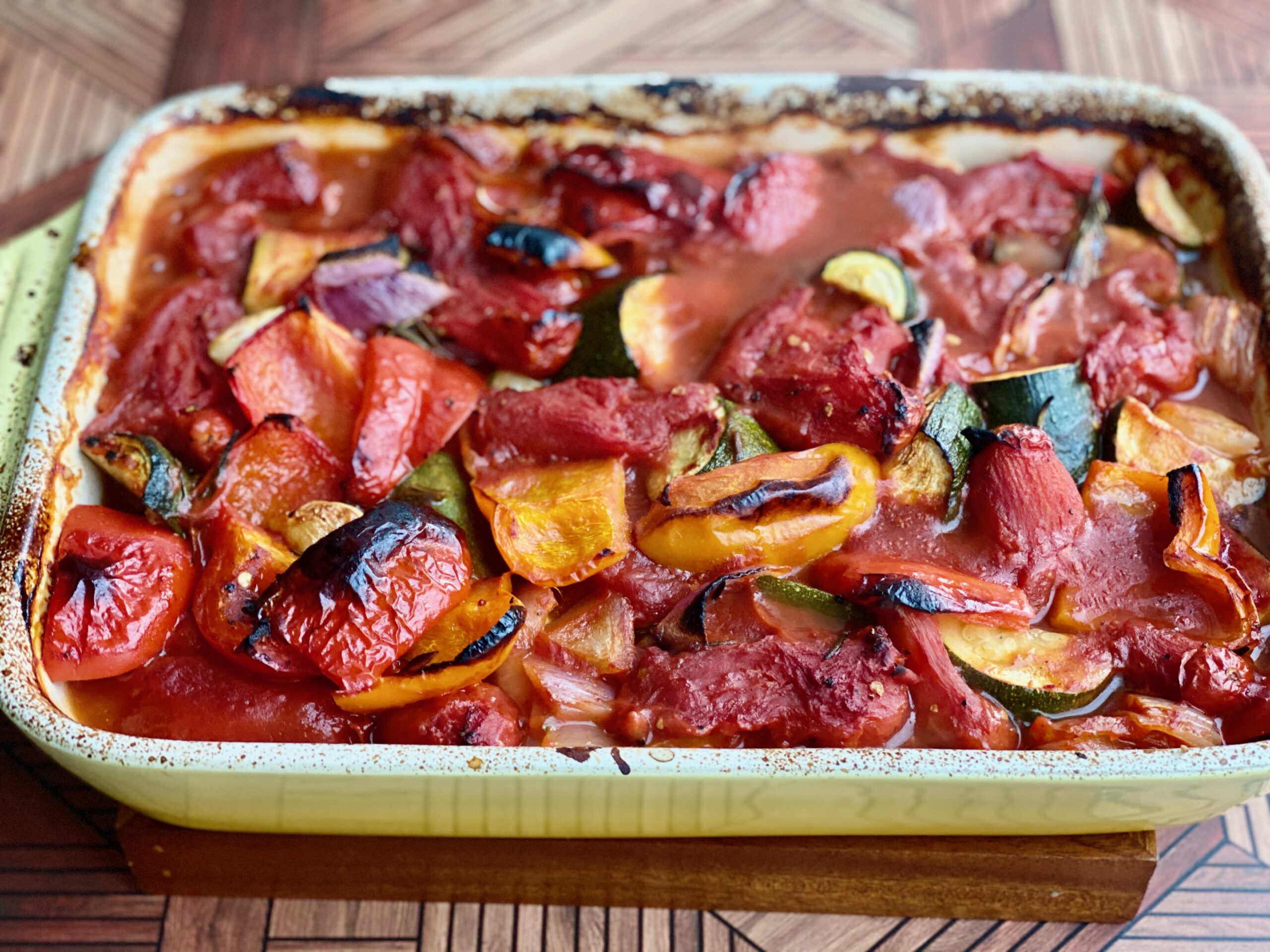 Easy Roasted Tomato Vegetable Soup An image of a pan full of charred, roasted vegetables