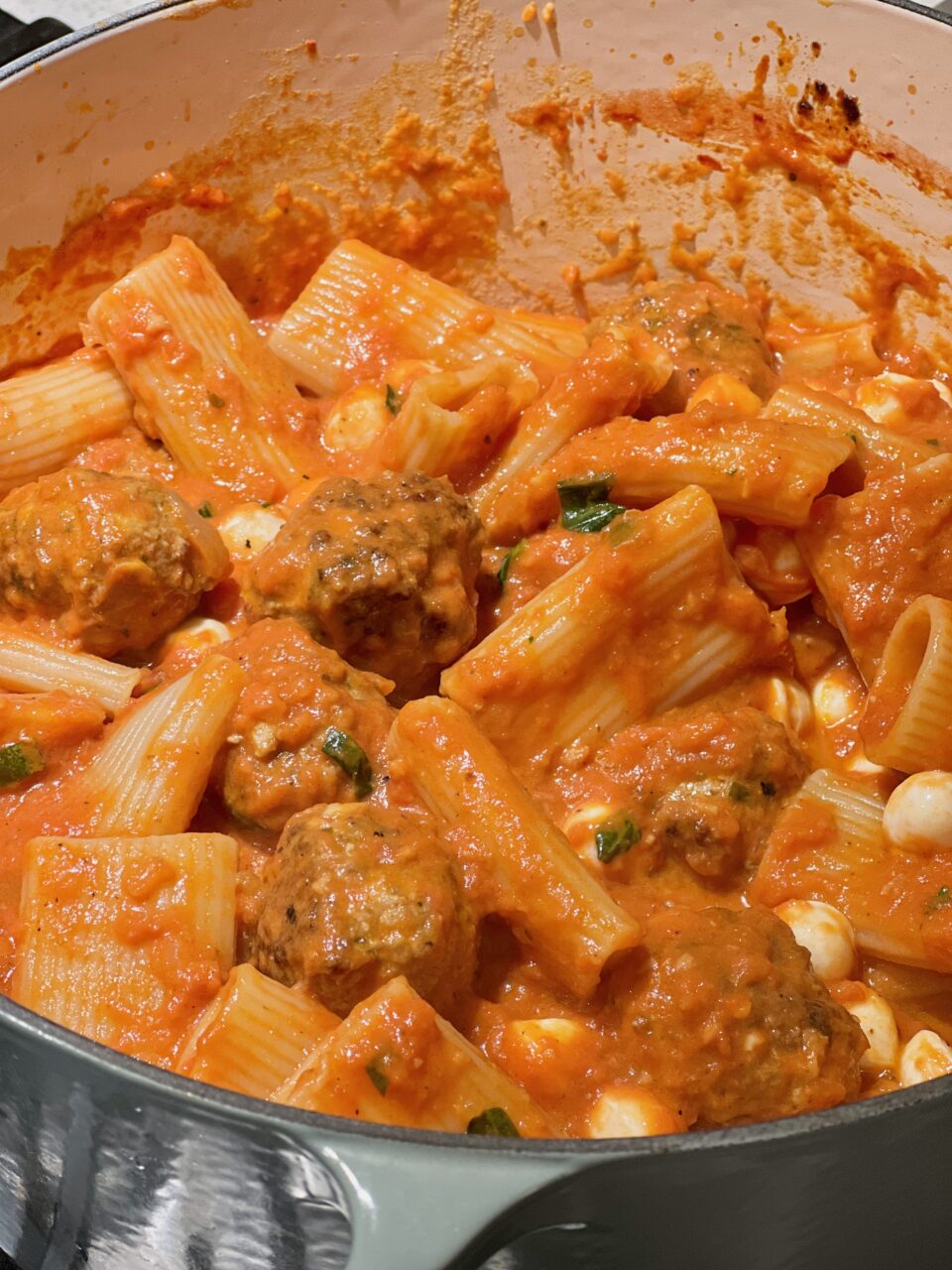 Meatballs with Tomato Cream Sauce A large pot of tomato sauce cooking with meatballs