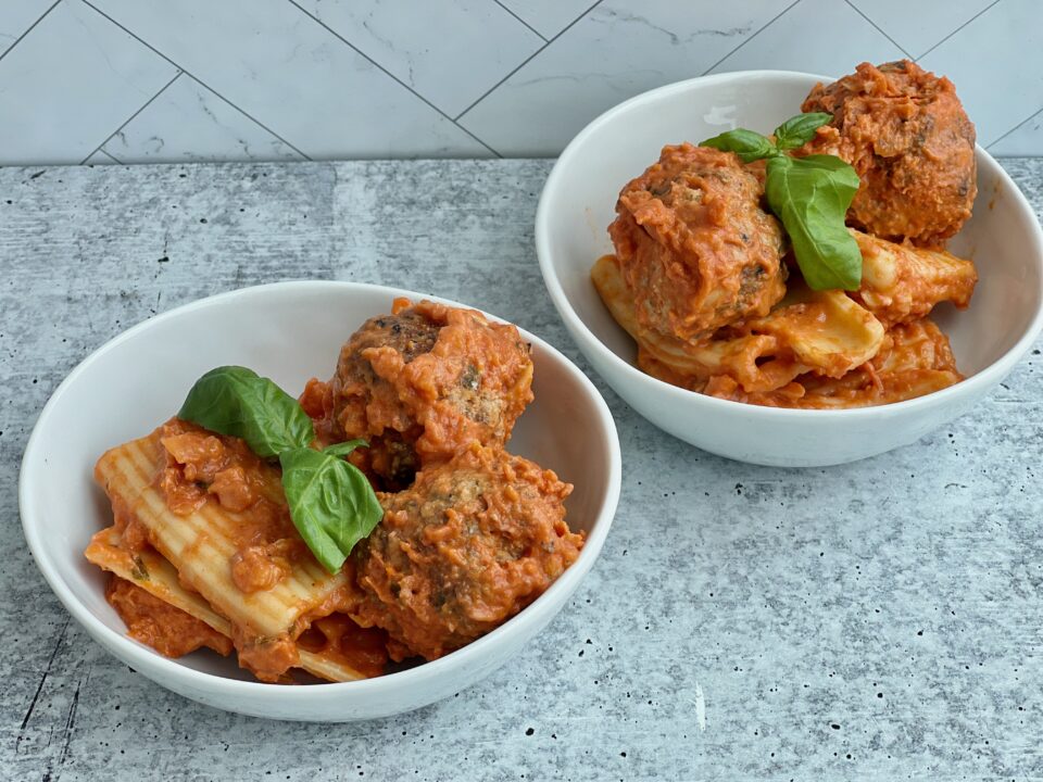 Meatballs with Tomato Cream Sauce Two bowls with pasta and meatballs