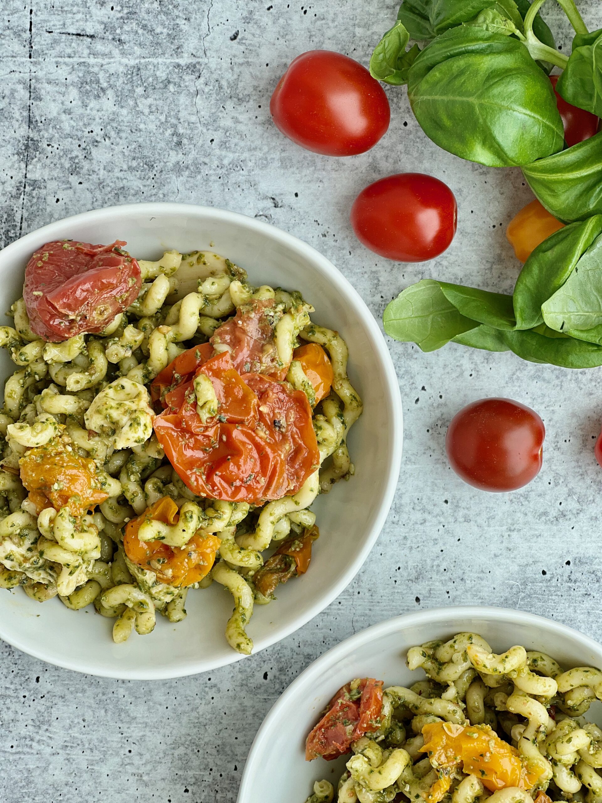 Easy Pesto Pasta with Roasted Tomatoes A bowl of pesto pasta with roasted tomatoes in it